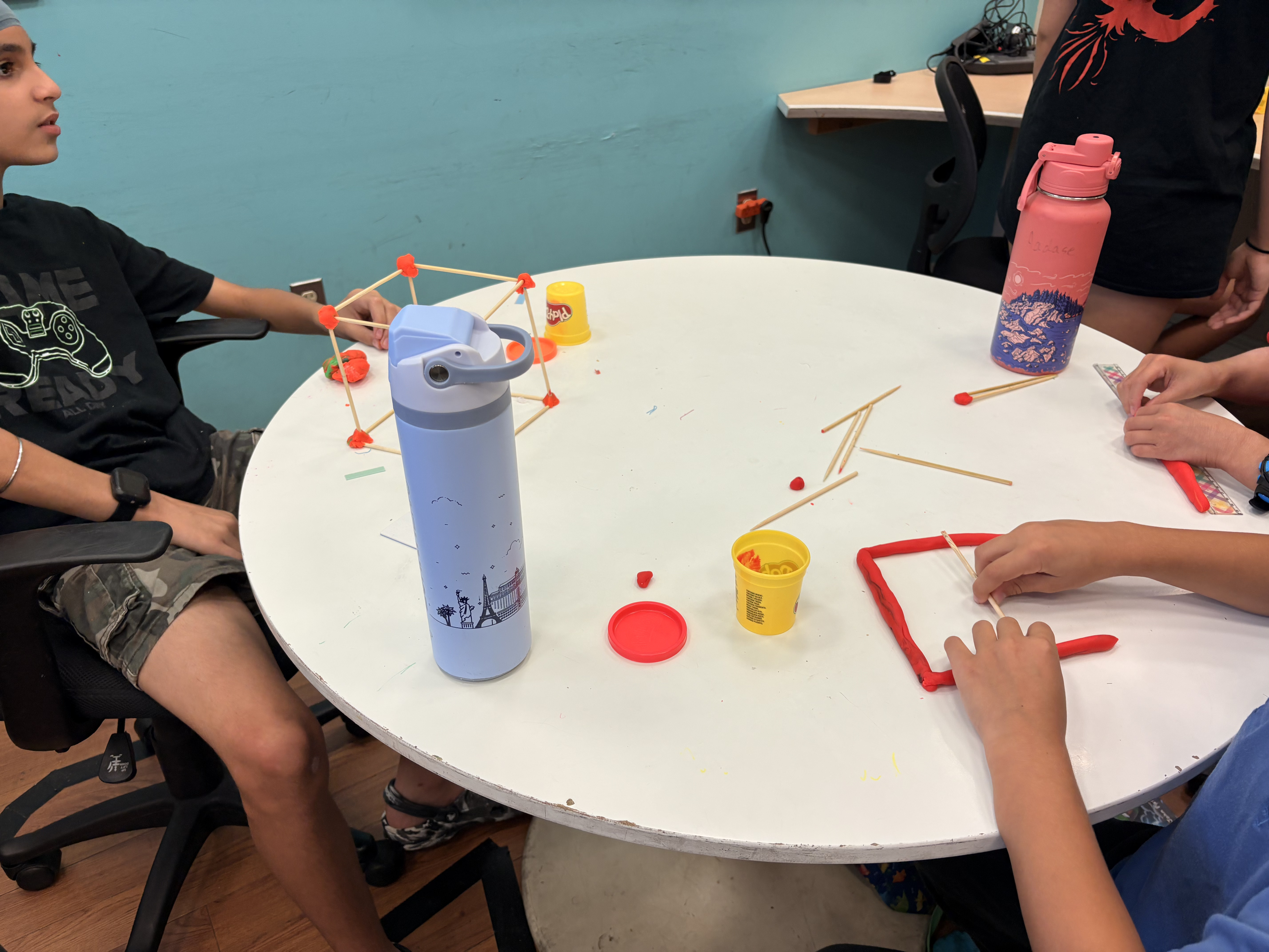 Students building and testing structures during a plantingSTEMs engineering workshop