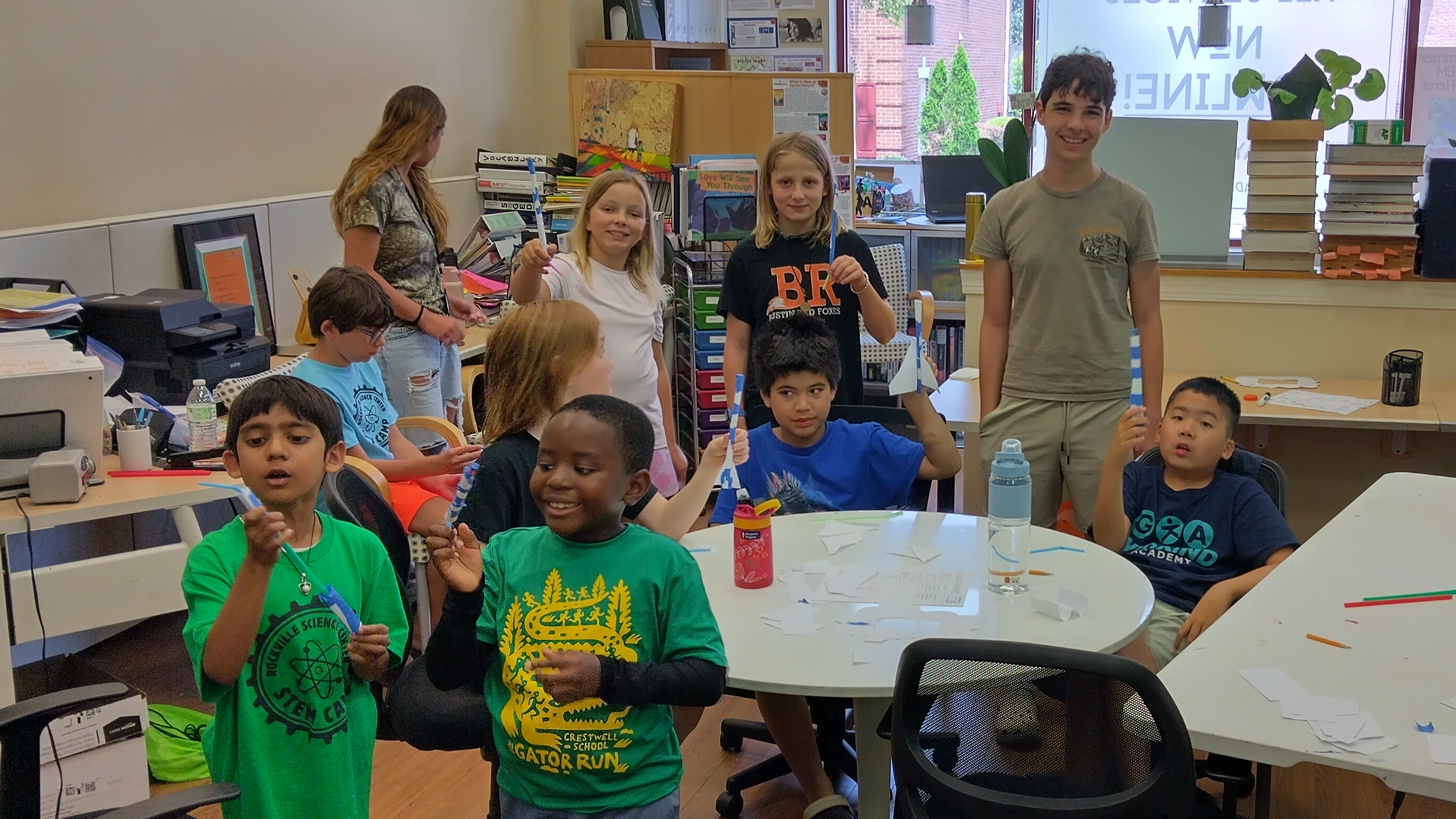 Kids with potted seedlings at a workshop